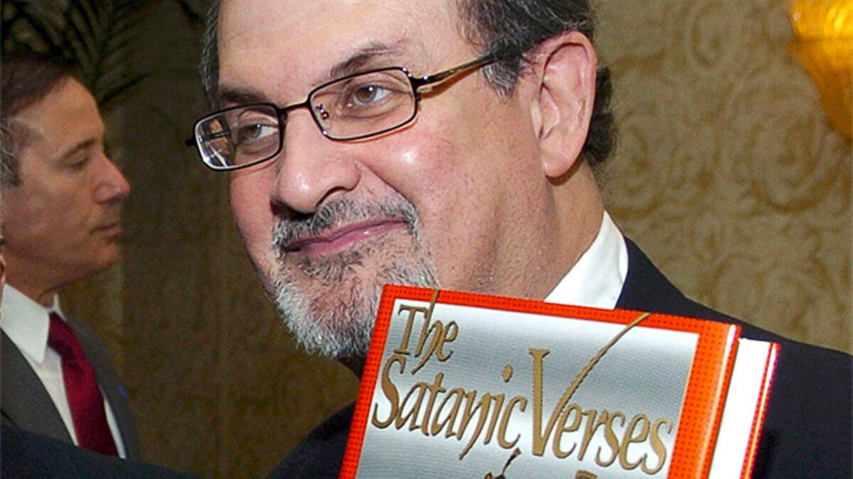 Salman Rushdie with his famous novel The Satanic Verses. 